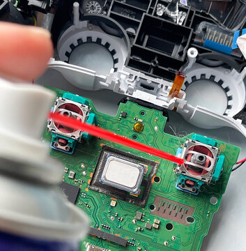 Cleaning and repairing game controller joystick, gaming maintenance and electronics repair concept
