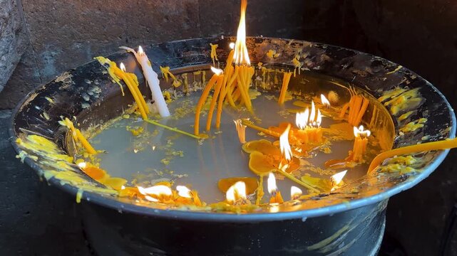 serene candlelight reflection in a circular water table sacred church interior medieval stone architecture for prayer ritual devotion faith and flame glow with shadow in silence respectful atmosphere