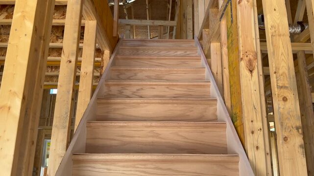 Static shot of stairs in a new home build during the structural skeleton stage highlighting high-quality craftsmanship. Perfect for subcontractor inspection and property development projects.