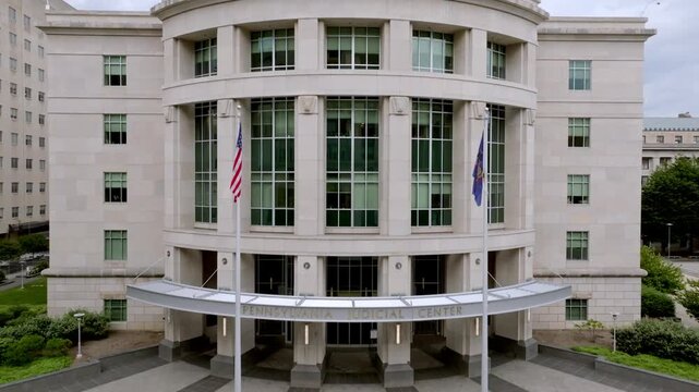 Exterior of Pennsylvania Judicial Center in Harrisburg, Pennsylvania with drone video moving down.
