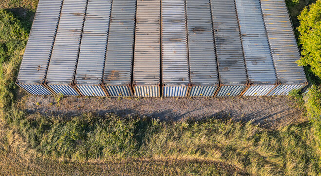 Aerial view of rows of stacked shipping containers at an industrial site, Le Pouzin, Auvergne-Rhone-Alpes, France.