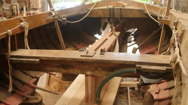 Interior of traditional wooden clinker sailboat shipwright repair