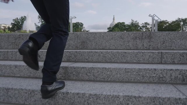 Business man walking stairs for success story. Businessman climbing stairs as motivation symbol. Business man stepping up stairs career ladder. Businessman walking stairs outdoors in city.