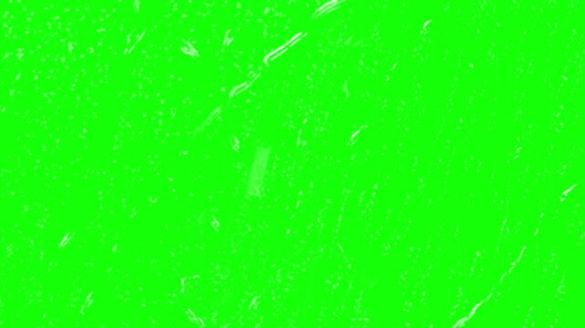 Raindrops fall gently against a vibrant green screen backdrop for visual.