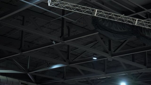 Metal roof trusses and ceiling structure inside a large hall or center. Industrial steel framework supporting lighting, ventilation, and event equipment.