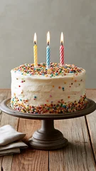 Birthday cake with three candles and colorful sprinkles, vertical photo celebrating a joyful party, sweet dessert and festive childhood birthday moment © annebel146