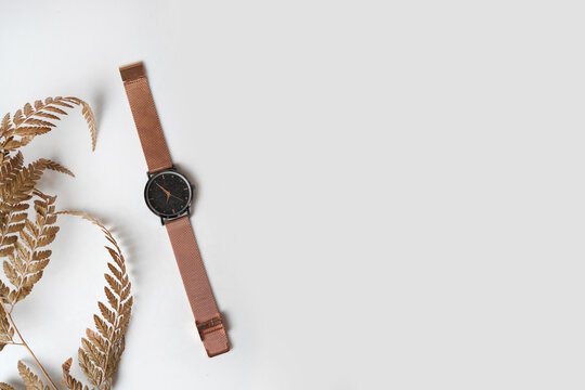 Elegant Rose Gold Wristwatch with Black Dial and Mesh Strap on Clean White Background
