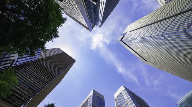 A timelapse of cloud reflecting the office building in the city looking up view tilt