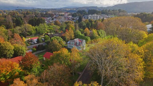 Panoramic aerial view of Teja Island in Valdivia, Chile the Sch&uuml;ler House and Rudolph Amandus Philippi Museum set against an autumnal natural backdrop