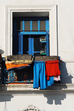 Algeria, Algiers, clothes hanging on clothesline for drying in the blue balcony of residential building