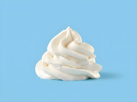 A swirl of fresh white whipped cream on a light blue background