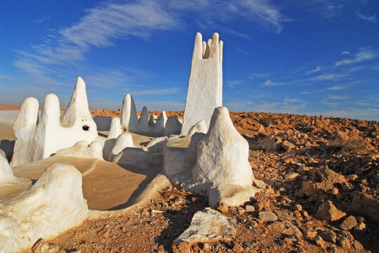 Algeria, Melika, entrance to Melika's cemetery in the background, and with a white bright watch tower in the background