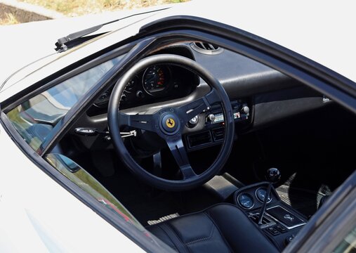 Azzida, Italy. July 4 2026. Steering wheel, signed Nardi design, and dashboard of iconic Ferrari 308 GTB, vintage sports car from Seventies and Eighties, during a car rally.