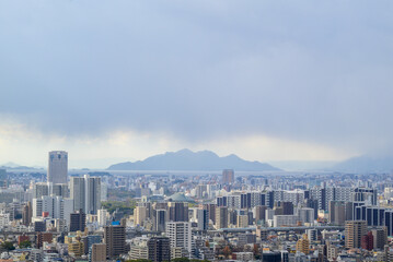 Fototapeta premium Panoramic view of Hiroshima city skyline under a dramatic cloudy sky