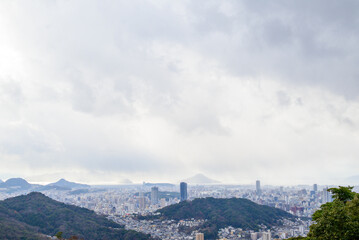 Naklejka premium Panoramic aerial view of Hiroshima city under dramatic cloudy sky