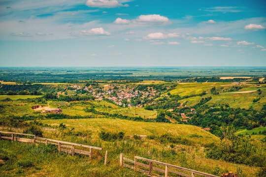 Scenic rural panorama of Bukovac village surrounded by fields and hills in Vojvodina, Serbia, peaceful agricultural landscape