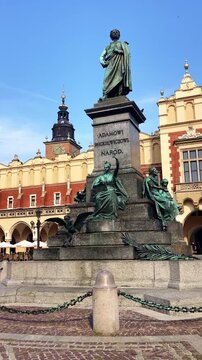The Adam Mickiewicz Monument stands proudly in the heart of the historic square celebrating Polish literature and cultural heritage in Krakow, Poland