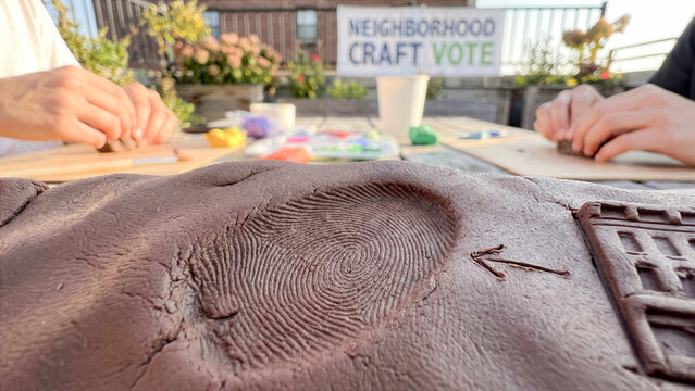 Fingerprint ridge pressing into brown modeling clay to vote architectural detail on roof assembly