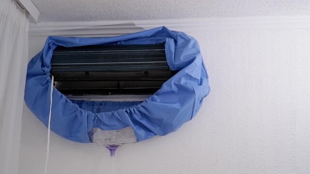 Dirty water draining from an air conditioner unit during professional cleaning and maintenance service