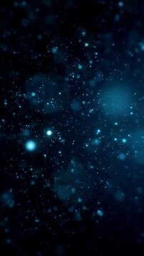 Glowing blue particles floating on a dark background, vertical video featuring elegant light effects, atmospheric motion and futuristic digital energy