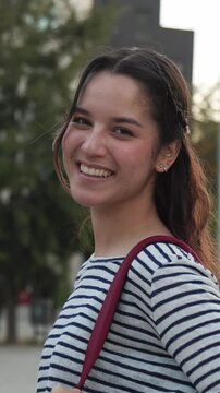 Happy young woman smiling cheerfully outdoors
