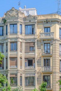 Barcelona, Residential Building Facade with Ornate Windows, Classical Decorative Details, Elegant Urban European Architecture