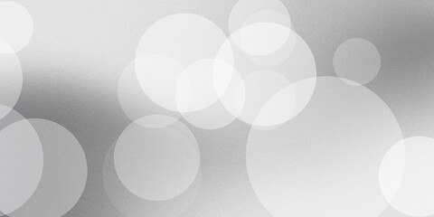 Abstract background featuring soft circular bokeh lights in white and grey gradients creating elegant smooth modern visual effect. © mek
