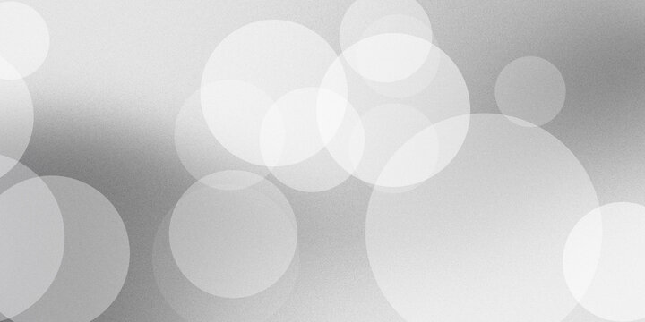 Abstract background featuring soft circular bokeh lights in white and grey gradients creating elegant smooth modern visual effect.