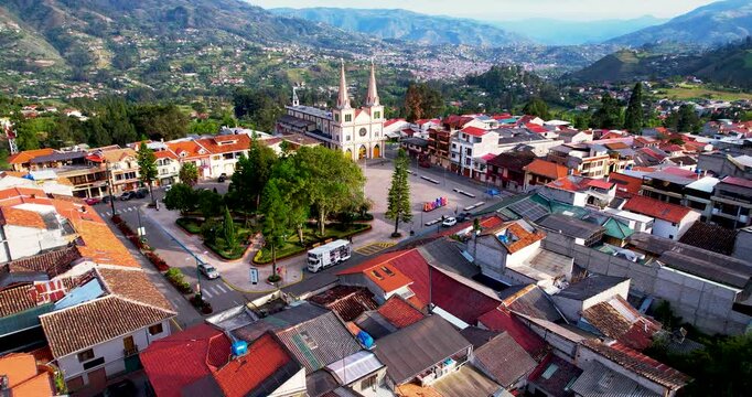 Beautiful aerial drone orbit shot of the historic church and central park in Chordeleg Ecuador captured on a sunny afternoon perfect broll footage for travel and tourism documentaries