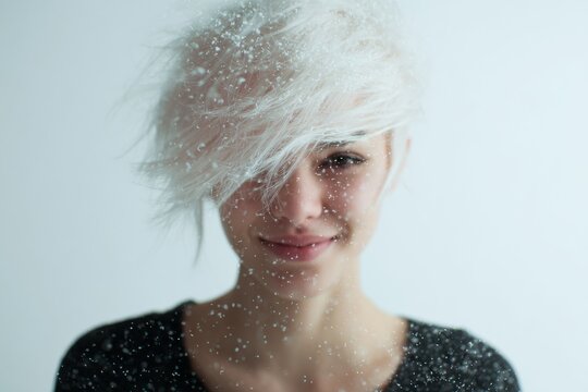 Playful woman with bright short hair and sly smile sparkling particles for portrait background and lifestyle banner
