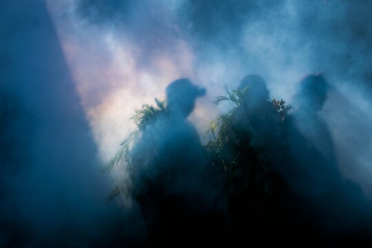 Shamanic group in smoke with blue light and silhouettes for communal ritual background and spiritual storytelling poster