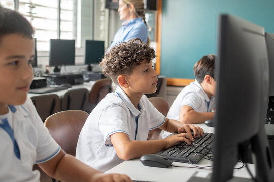 Elementary School Boys Using Desktop Computers in class