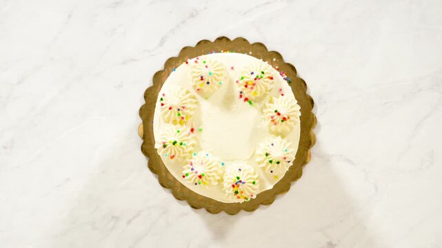 Hands Holding Decorated Vanilla Cake