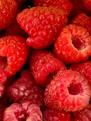 Vertical macro close up of fresh raspberry on natural background © ku4erashka