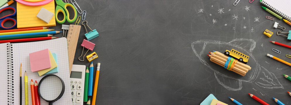 Back to school concept over classroom blackboard. Top view