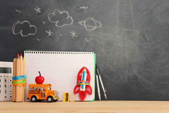 Back to school concept over classroom blackboard. Top view