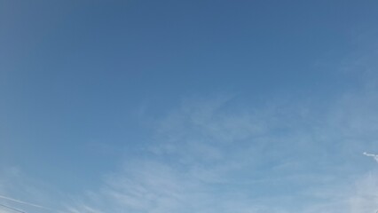 Soft clouds drifting across evening sky © creativediastudio