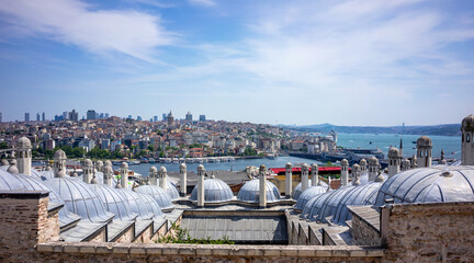Ottoman mosque domes frame a breathtaking panoramic view of Istanbul's cityscape stretching across the Golden Horn to the Galata Tower and the modern skyline beyond. © Mirador