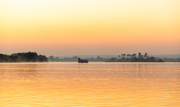 vintage boat on Zambezi River, Zambia, Africa at sunrise