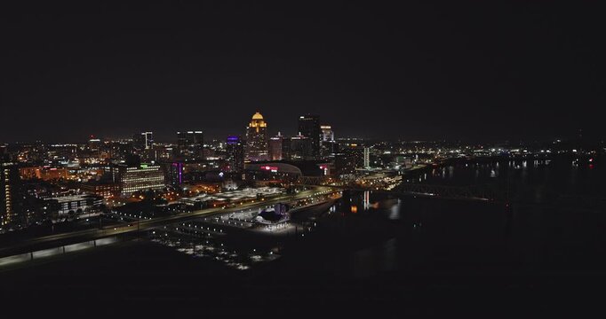 Louisville Kentucky Aerial v41 cinematic low drone flyover Ohio river capturing riverside traffic, bridge, and illuminated downtown cityscape at night - Shot with Inspire 3 8k - Sept 25th 2023