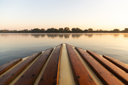 mist, fog, and palm trees at sunrise on the Zambezi River, Zambia, Africa
