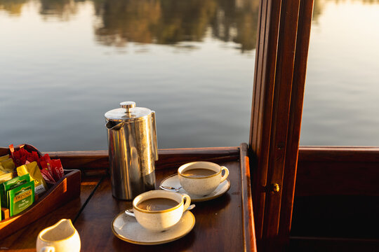 tea cups and Zambezi River at sunrise, Zambia,Africa