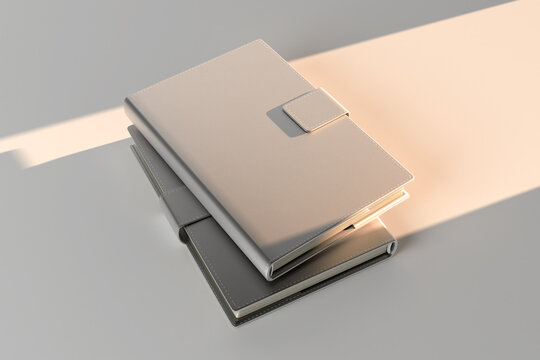 Leather diary mockup with magnetic buckle, blank white and black cover notebook templates stacked on gray background, elegant organizer or planner with sunset sunlight beam, realistic 3d render