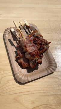 mu ping or grilled pork skewers are a popular thai street food dish, vertical snapshot for social media with copy space