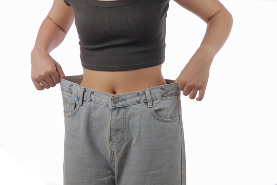 Weight loss transformation woman showing loose jeans after injection pen treatment happy result