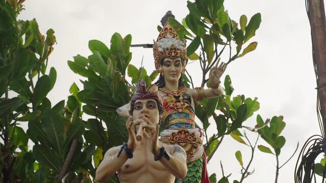Traditional balinese hindu god statues among trees