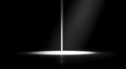 Cinematic spotlight beam hitting a dark floor with subtle dust in a black background room. © wahris