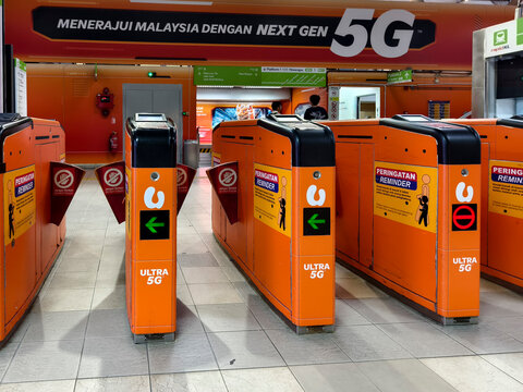 Kuala Lumpur, Malaysia - March 8, 2026: Orange ticket barriers inside Imbi monorail station entrance for public transport passengers.
