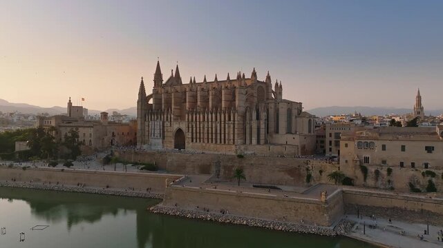 Mallorca, Spain - Aerial view of the Catedral-Basilica de Santa Maria de Mallorca at sunset with skyline view of Palma de Majorca, the capital city of the island