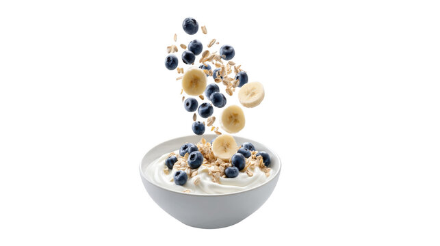 Fresh yogurt bowl with falling blueberries bananas and healthy oats isolated on transparent background